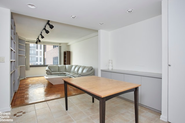 interior space featuring light tile patterned flooring and rail lighting