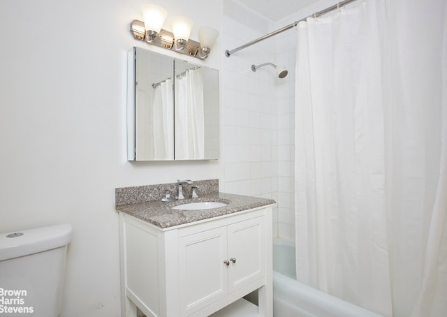 bathroom featuring toilet, shower / bath combo with shower curtain, and vanity