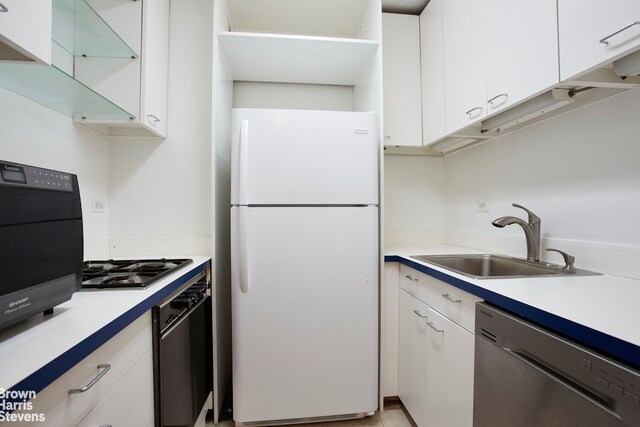 44 W 62nd St Unit 6E, New York City, NY 10023 - kitchen featuring stainless steel appliances, a sink, white cabinets, and light countertops