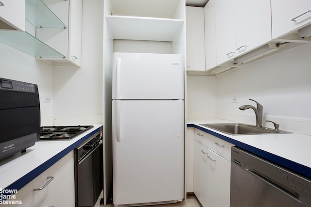 kitchen featuring stainless steel appliances, light countertops, and white cabinetry