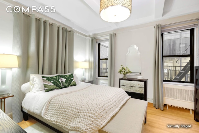 bedroom with baseboards and wood finished floors