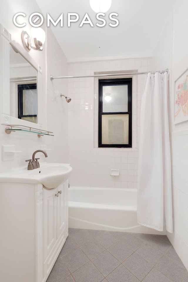 bathroom featuring vanity, tile walls, and shower / tub combo with curtain