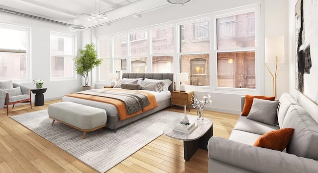 bedroom featuring a chandelier, wood finished floors, and baseboards