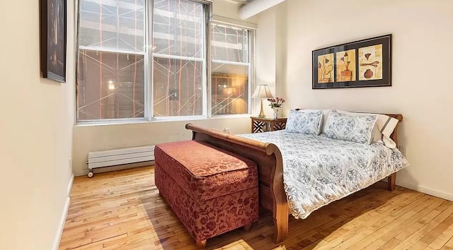 bedroom featuring baseboards and hardwood / wood-style floors