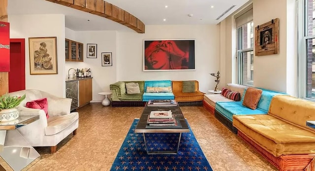 living room with tile patterned floors, visible vents, and beverage cooler