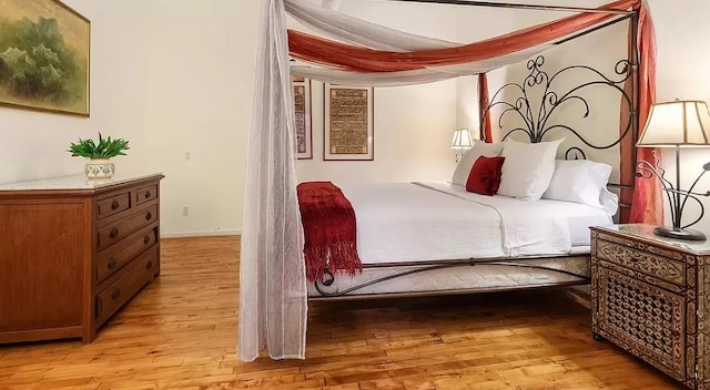 bedroom with light wood-style flooring and baseboards