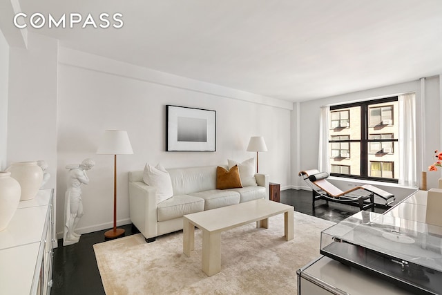 living room featuring baseboards and wood finished floors