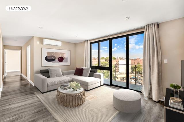 living area with wood finished floors, visible vents, baseboards, a wall mounted AC, and expansive windows