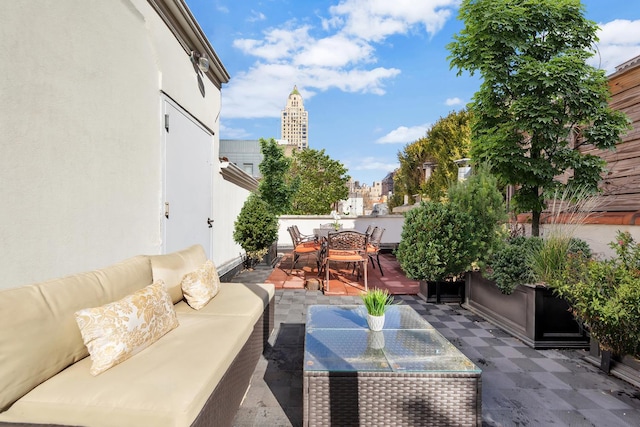 view of patio / terrace with a view of city, an outdoor hangout area, and outdoor dining area