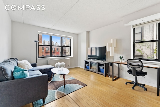 living area featuring wood finished floors and baseboards