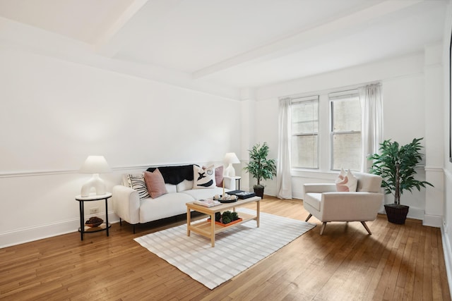 17 E 96th St Unit 5C, New York City, NY 10128 - living area featuring light wood-style floors, beam ceiling, and baseboards
