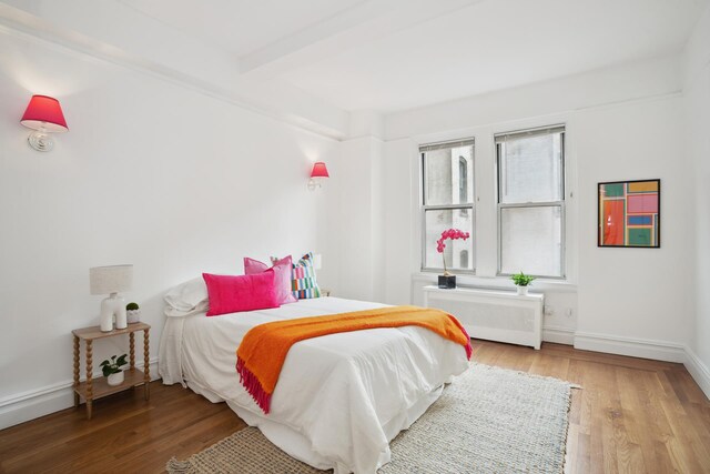 17 E 96th St Unit 5C, New York City, NY 10128 - bedroom featuring beam ceiling, light wood-style floors, and cooling unit