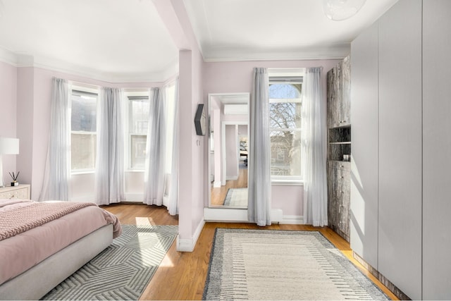 bedroom with light wood-type flooring and baseboards