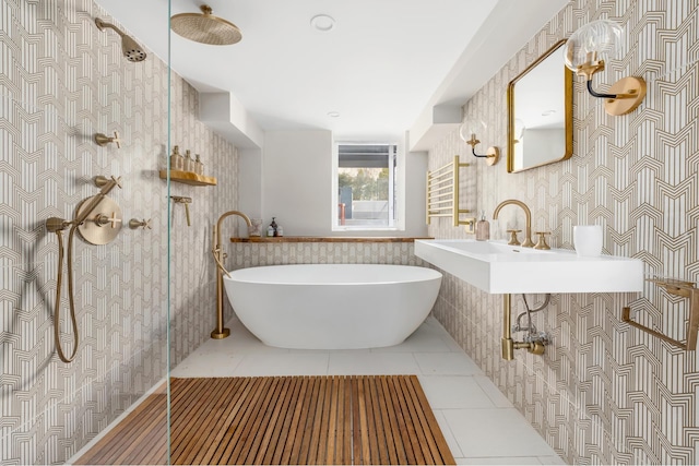 bathroom featuring tile patterned flooring, a soaking tub, tile walls, and a shower