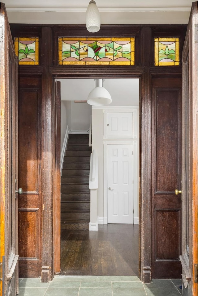 hall featuring stairway, wood finished floors, and baseboards