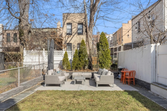 view of yard featuring a fenced backyard, outdoor lounge area, and a patio area