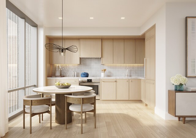 24-01 Queens Plz N Unit 703, New York City, NY 11101 - kitchen with backsplash, oven, light wood finished floors, and light countertops