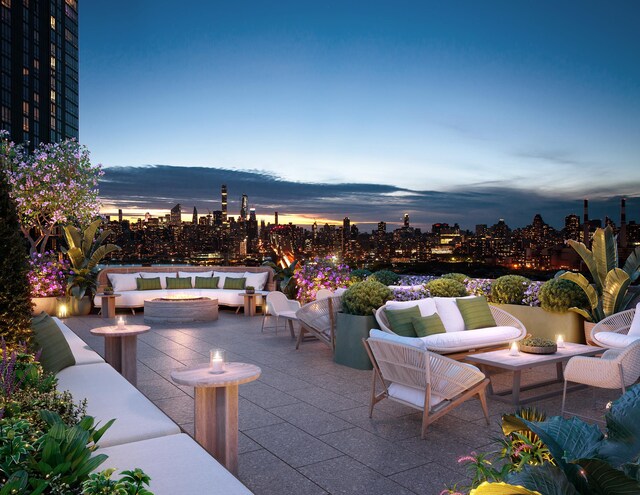 24-01 Queens Plz N Unit 703, New York City, NY 11101 - patio terrace at dusk with an outdoor living space with a fire pit