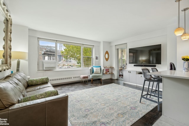 living area with wood finished floors and a baseboard radiator