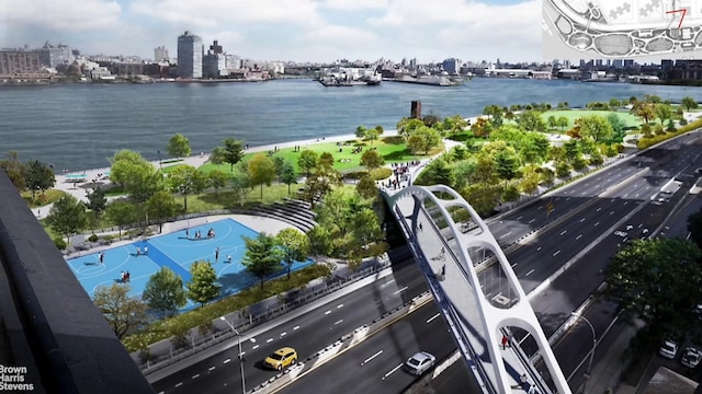 drone / aerial view featuring a city view and a water view