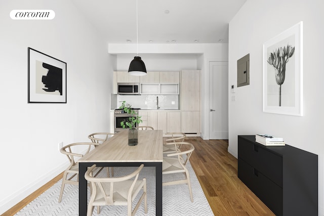 dining space with electric panel, visible vents, baseboards, and wood finished floors