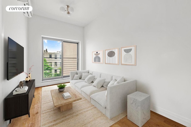 living area with wood finished floors and baseboards