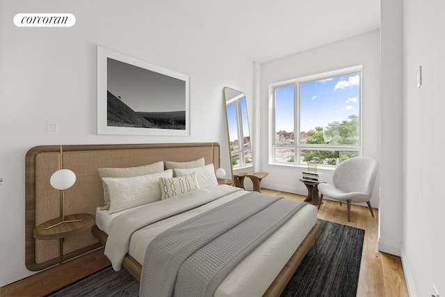 bedroom with light wood-style floors, visible vents, and baseboards