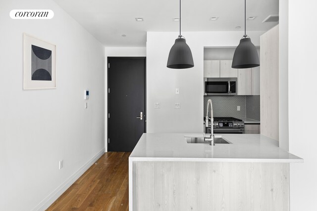 26 Goodwin Pl Unit 3F, New York City, NY 11221 - kitchen featuring backsplash, visible vents, modern cabinets, dark wood finished floors, and stainless steel appliances