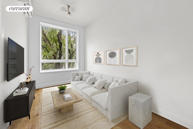 26 Goodwin Pl Unit 3F, New York City, NY 11221 - living room featuring baseboards and wood finished floors