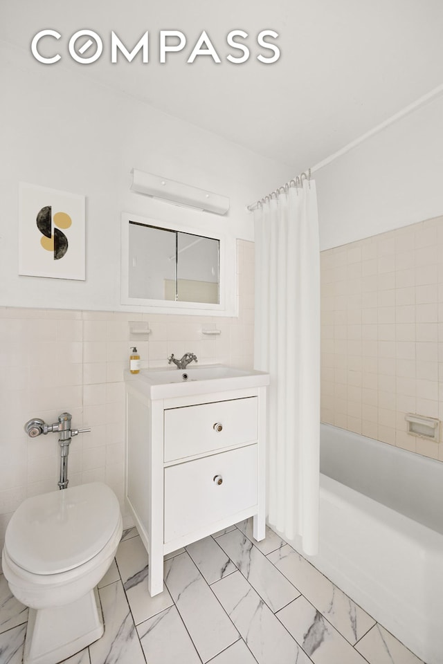 full bath with toilet, tile walls, vanity, marble finish floor, and shower / tub combo with curtain