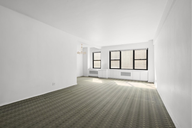 interior space with a notable chandelier and baseboards