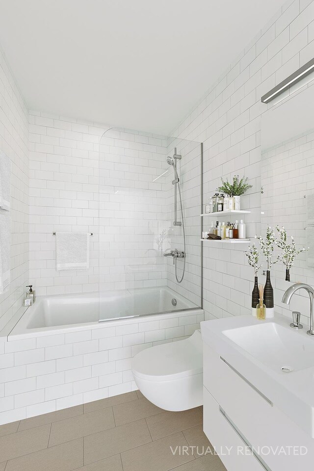 2 Tudor City Pl Unit 2Os, New York City, NY 10017 - bathroom with vanity, toilet, tiled shower / bath combo, tile walls, and tile patterned floors
