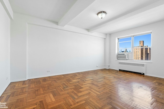 unfurnished room featuring baseboards, radiator heating unit, cooling unit, and beamed ceiling