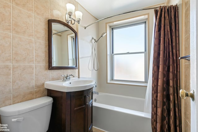 full bath featuring tile walls, shower / bath combo with shower curtain, toilet, and vanity