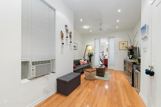 interior space with baseboards, wood-type flooring, cooling unit, and recessed lighting