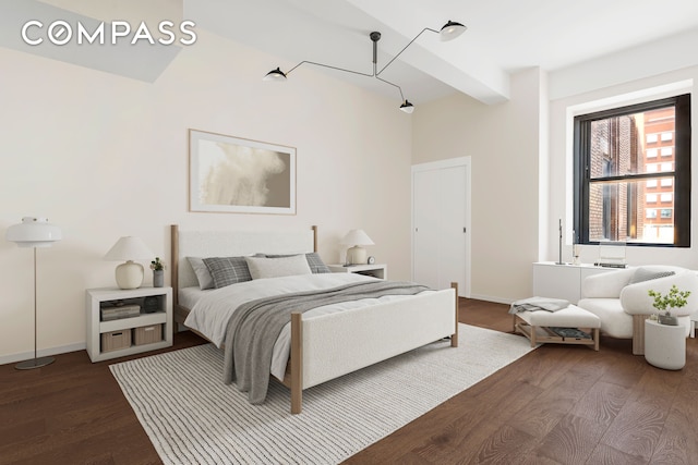 bedroom featuring dark wood-style flooring, beamed ceiling, and baseboards