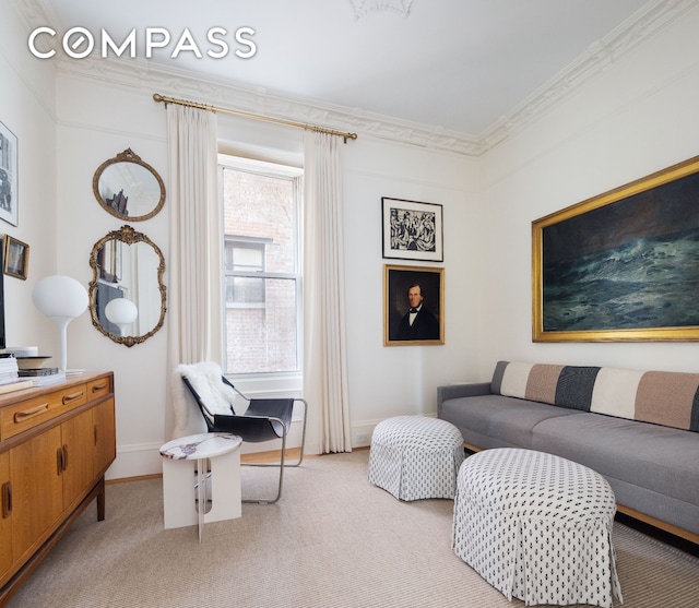 living area featuring ornamental molding, light carpet, and baseboards