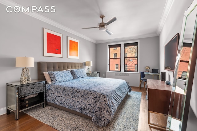 bedroom with ceiling fan, radiator heating unit, wood finished floors, and crown molding