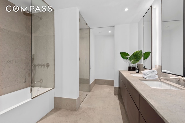 full bath with double vanity, shower / bath combination with glass door, a sink, and recessed lighting