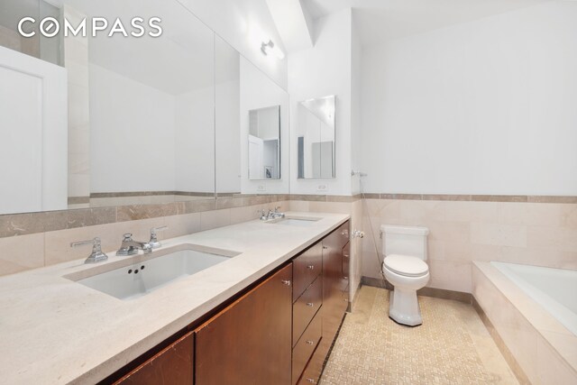 1 Hanson Pl Unit 15M, New York City, NY 11243 - full bath featuring double vanity, a relaxing tiled tub, tile patterned flooring, and tile walls