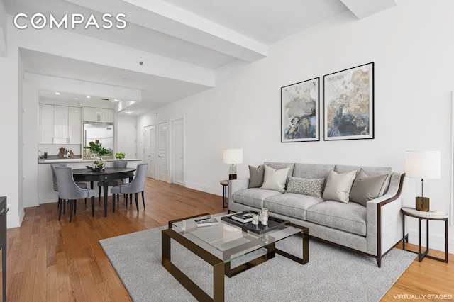 living room featuring light wood-style flooring and baseboards