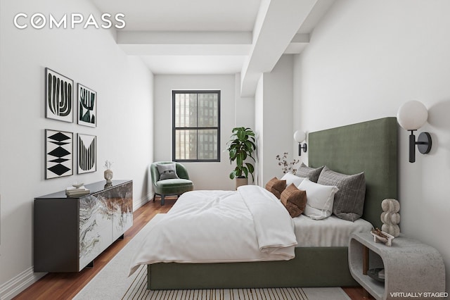 bedroom featuring dark wood-style flooring and baseboards