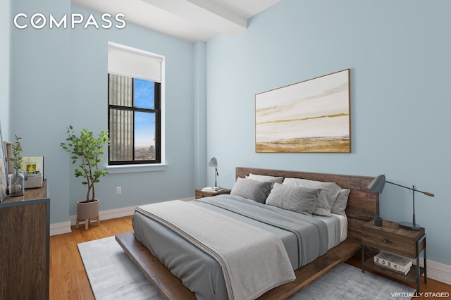 bedroom featuring light wood-style floors and baseboards