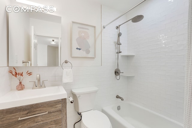 full bath with toilet, shower / bath combination, vanity, tile walls, and tasteful backsplash