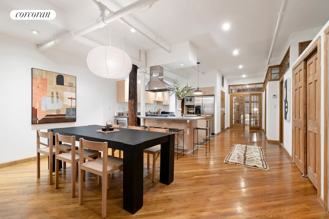 dining room featuring french doors, light wood finished floors, recessed lighting, visible vents, and baseboards