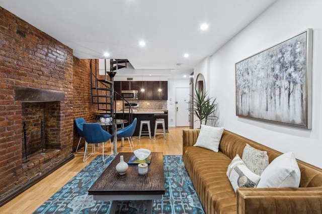 living area with recessed lighting, stairs, and wood finished floors