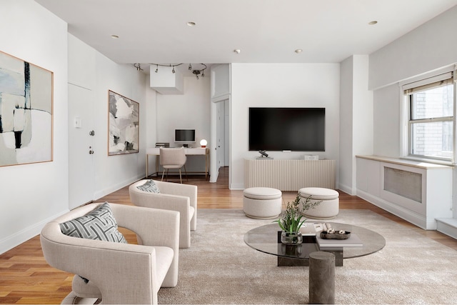 living area featuring recessed lighting, wood finished floors, and baseboards