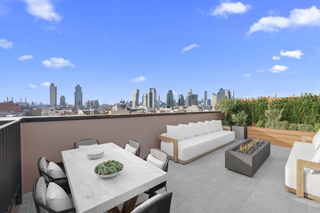 205 Java St Unit 3A, New York City, NY 11222 - view of patio featuring a view of skyline, an outdoor living space with a fire pit, and outdoor dining area
