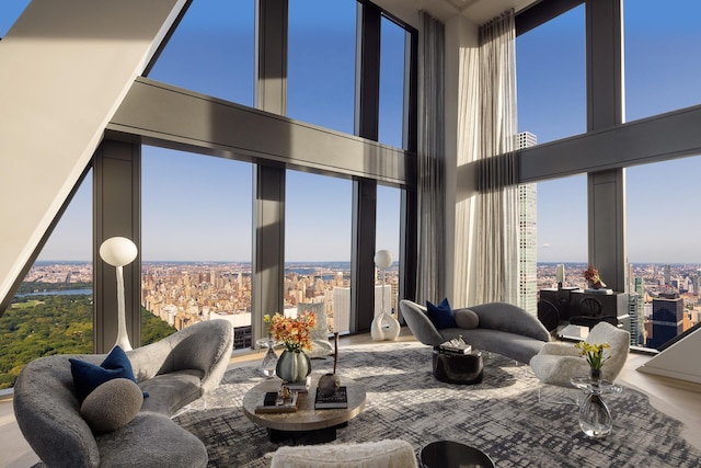 living area with expansive windows, plenty of natural light, and a city view