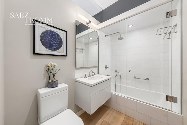 55 N Moore St Unit 4R, New York City, NY 10013 - bathroom featuring tiled shower / bath combo, wood finished floors, toilet, and vanity